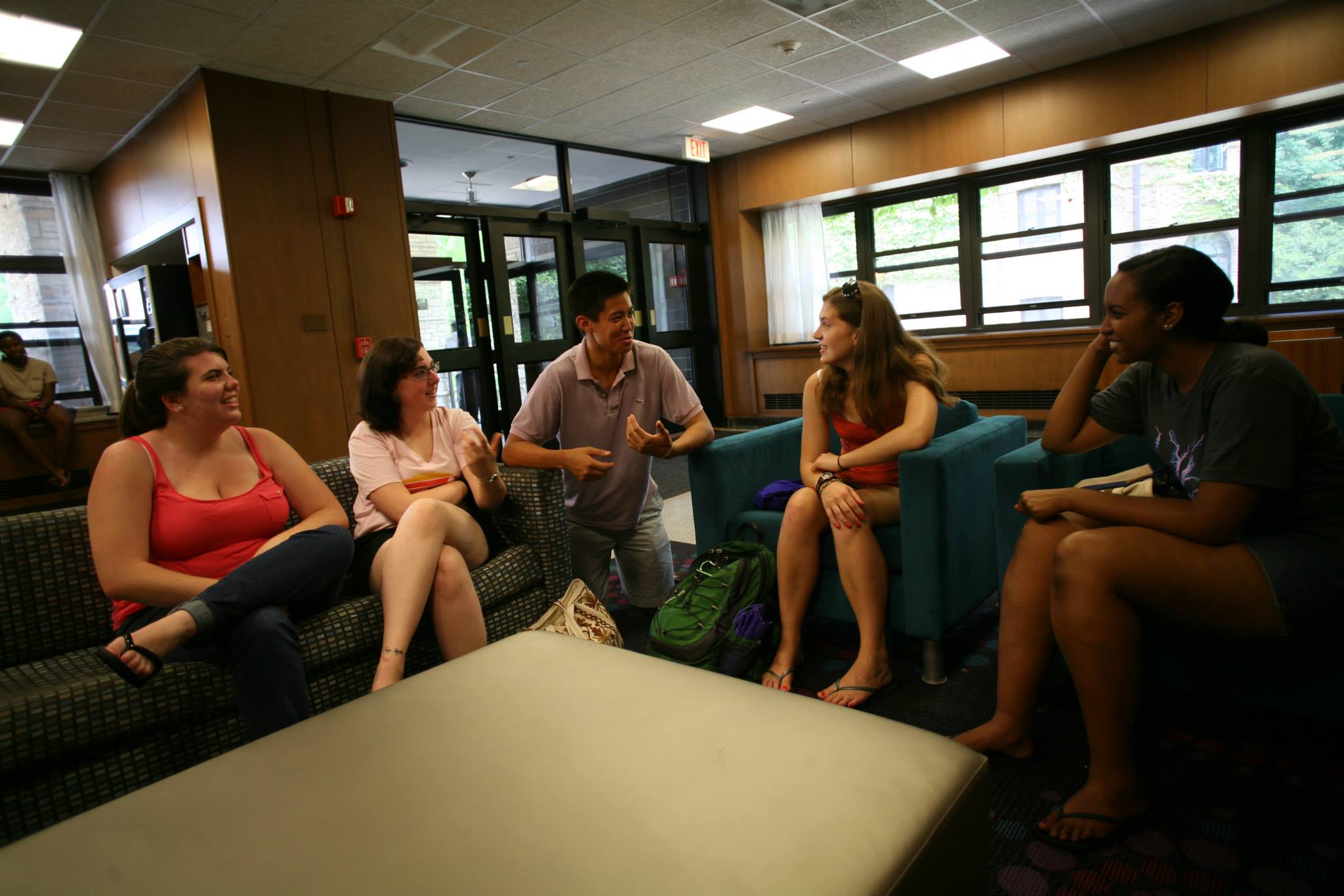 Students sitting in the Sargent Hall lobby